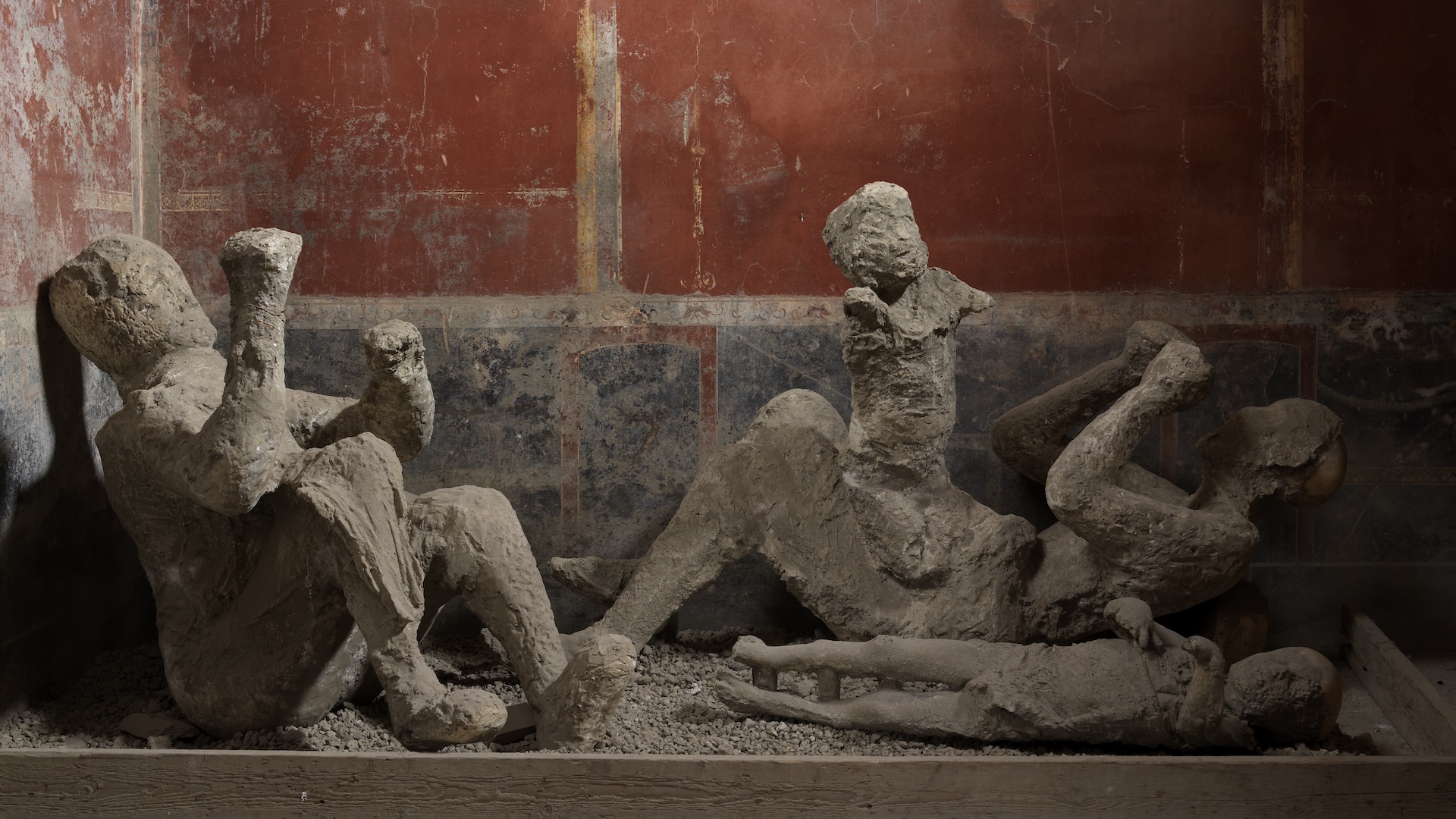 Archaeological casts showing a family buried beneath volcanic ash during the destruction of Pompeii in 79 CE