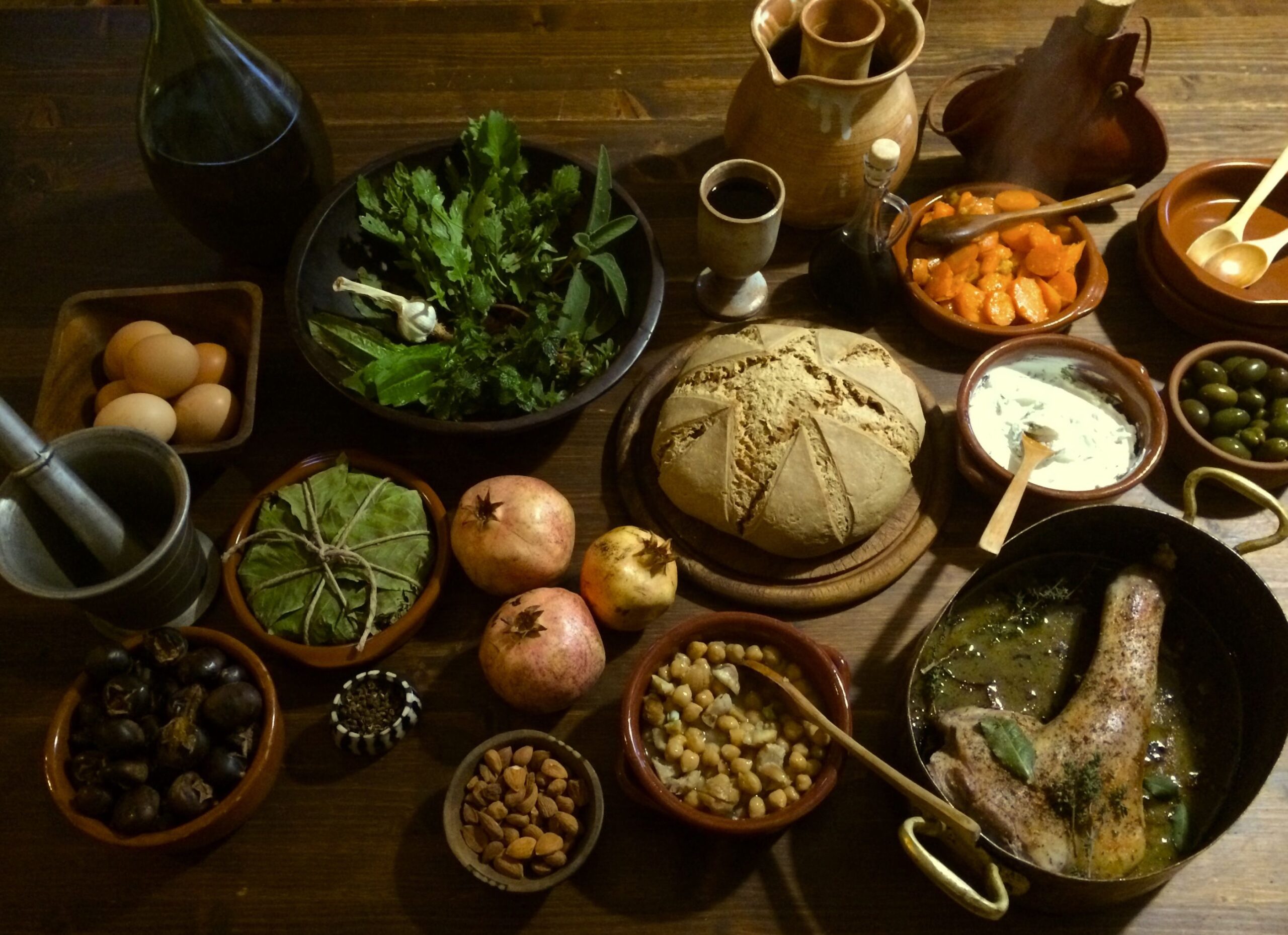 Roman foods including bread, figs, pomegranates, olives, vegetables, and traditional ancient stew