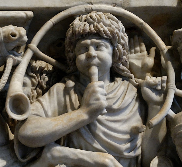 Roman military musician holding a cornu or tuba during an ancient military ceremony