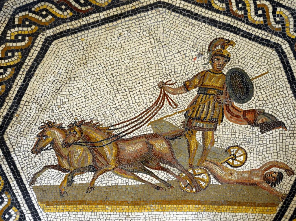 Ancient Roman mosaic depicting a charioteer standing beside his decorated racing chariot